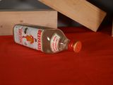a bottle of beer sitting on a table next to a wooden house