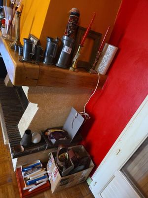 a piano in the corner of a room with a red wall