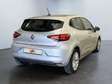 the rear end of a silver car in a white room