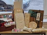 a table with various items on it in front of a window