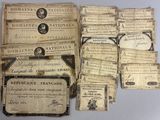 an assortment of old french currency and other papers on a table