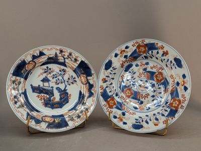 pair of blue and white plates with flowers and birds on them