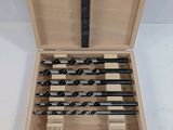 a wooden box with a set of drill bits in it