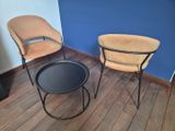 two chairs and a table in the corner of a room