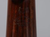 a close up of a wooden baseball bat with a baseball cap on it