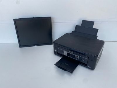 une imprimante et un écran posés sur une table