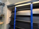 a room with shelves, shelves, and boxes in it