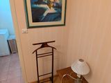 une photo d'une pièce avec du parquet et un tableau accroché au mur