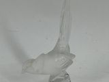 a glass bird that is sitting on top of a table