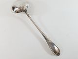 a spoon that is sitting on a white table
