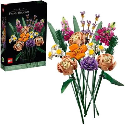 un bouquet de fleurs devant une boîte de Lego