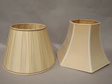 two lamps are shown on a gray surface with a gray background