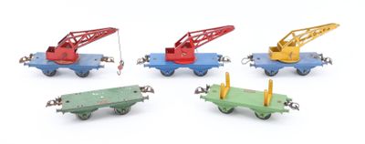 four toy trains with a crane on each of them