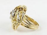 an image of a gold and silver ring with a diamond center
