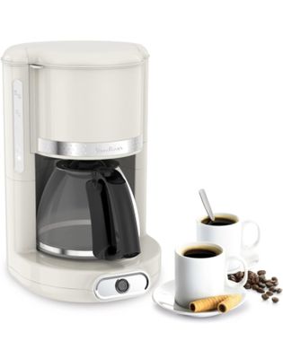 a white coffee maker with a cup of coffee next to it