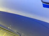 a close up of a car ' s hood with a blue paint job on it