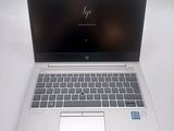 hp laptop computer on a white table with a blue sticker on the screen