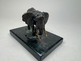 a statue of an elephant on a marble base
