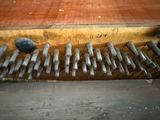 a lot of screws that are on the side of a wall