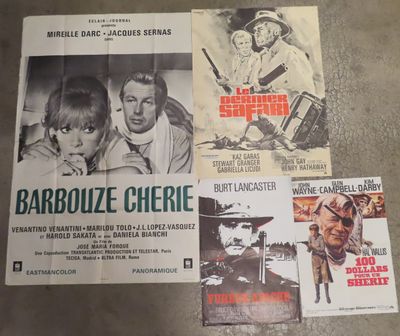 several movie posters on a table in a room