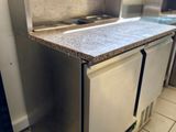 a kitchen with a sink, stove, and refrigerator in it