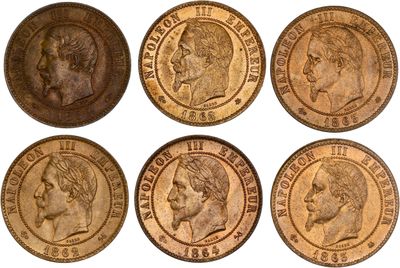 a close up of six different types of coins on a white background