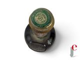 a close up of a bottle with a green lid