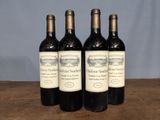 three bottles of wine sitting on top of a wooden table