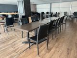 tables and chairs in a large room with wood floors and white walls