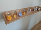 a wooden shelf that has several different types of soaps on it
