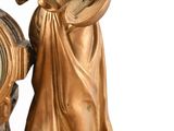 a statue of a woman playing a musical instrument next to a clock