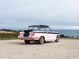a pink car that is parked on the side of the road