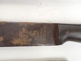 a knife that is sitting on a table next to a knife