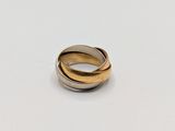 a close up of a gold and silver ring on a white surface