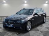 a picture of a black bmw wagon parked in a garage