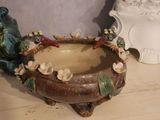 a ceramic bowl with birds on it sitting on a table