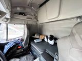 an image of the inside of a van with a dog sleeping on the seat