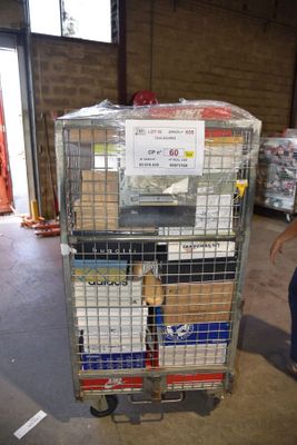 a man standing next to a cart with boxes on it