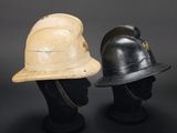 two helmets are sitting on top of each other on a mannequin head