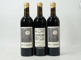 trois bouteilles de vin posées sur une table blanche