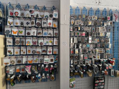 a picture of a wall of pins and magnets in a store
