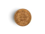 a close up of a gold coin on a white surface