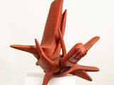 sculpture of a bird made of clay on a white pedestal