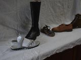 several pairs of shoes are lined up on a white table