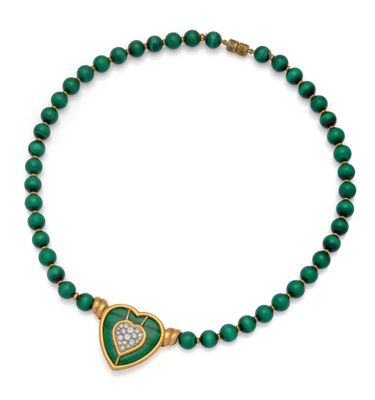a green and gold necklace with a heart shaped pendant