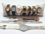 a lot of watches that are sitting on a pillow