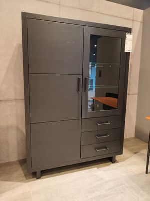 a cabinet with drawers and a desk in the corner