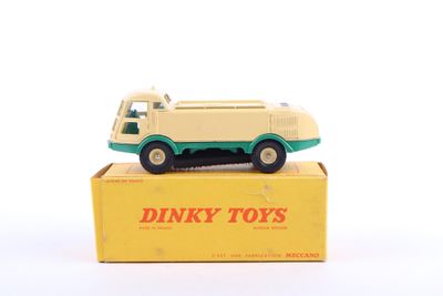 an old toy truck sitting on top of a box on a white surface