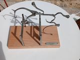 a small table with a metal sculpture on it