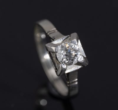 a close up of a diamond ring on a black surface